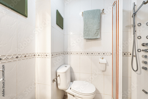 A simply designed bathroom with a white walk-in shower and central valance tiles