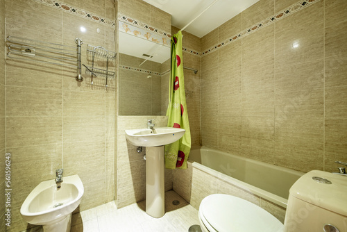 bathroom with bathtub  rectangular mirror attached to the wall and green curtains in the shower