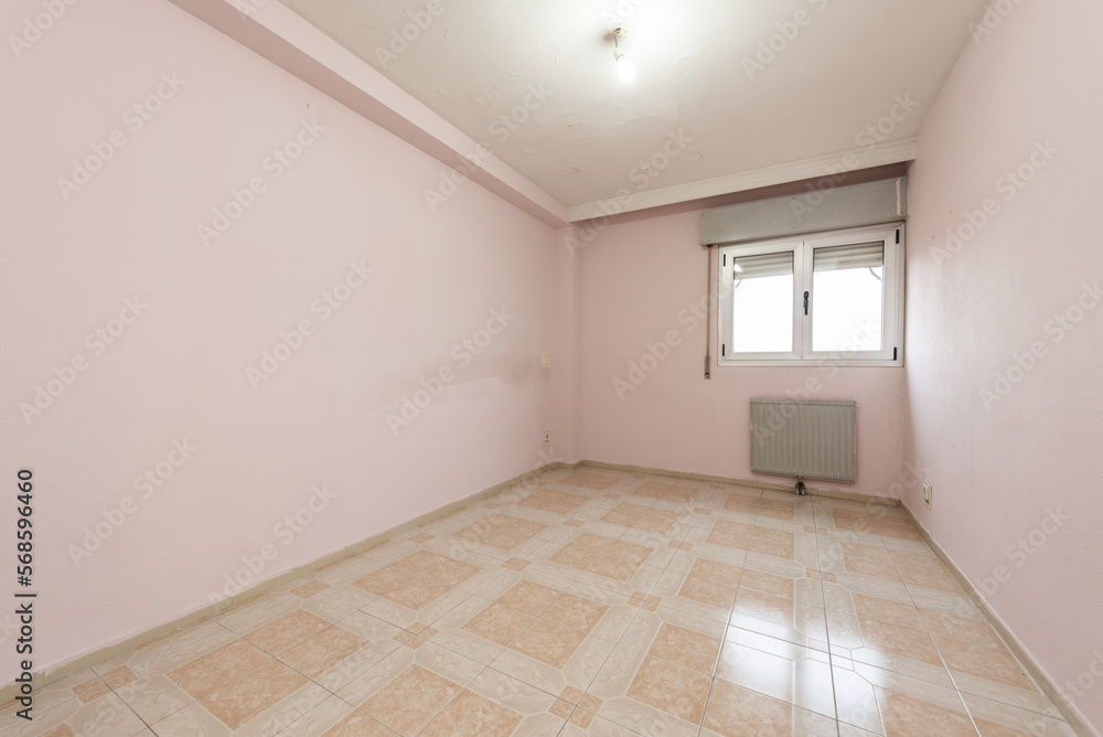 Totally empty room with pink painted walls and old stoneware floors in two color tones Totally empty room with pink painted walls and old stoneware floors in two color tones