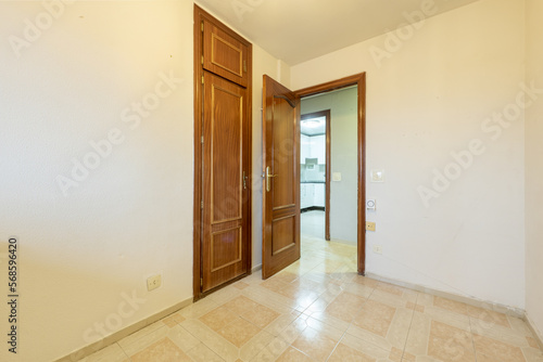 Wallpaper Mural Empty room with a built-in wardrobe with sapele doors to match the access door and two-color stoneware floors Torontodigital.ca