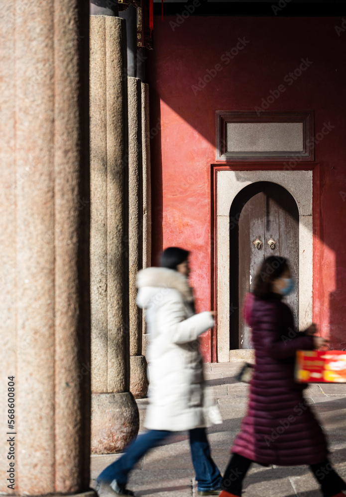 Two blurred walking people in motion in the temple. Two blurred walking people in motion in the temple.