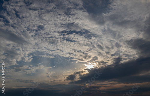 sky replacement sun peeking through dark gray clouds