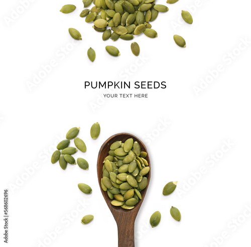 Creative layout made of pumpkin seeds and wood spoon on a white background. Top view.  
