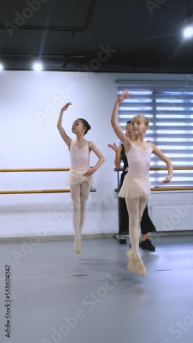 girls dancing ballet in class with teacher, vertical video