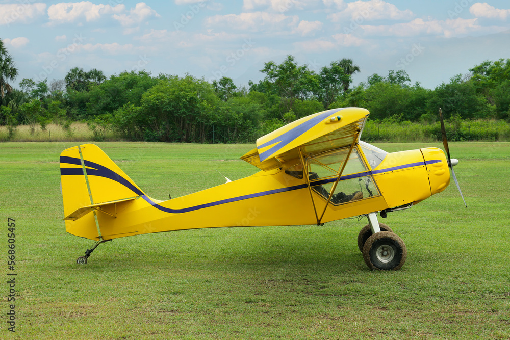 View of beautiful ultralight airplane in field on autumn day View of beautiful ultralight airplane in field on autumn day