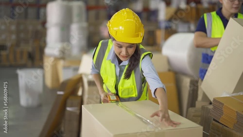 Teamwork of Asian workers working in large warehouse store industry.Rack of stock storage. Interior of cargo in ecommerce and logistic concept. Depot. People lifestyle. Shipment service for container