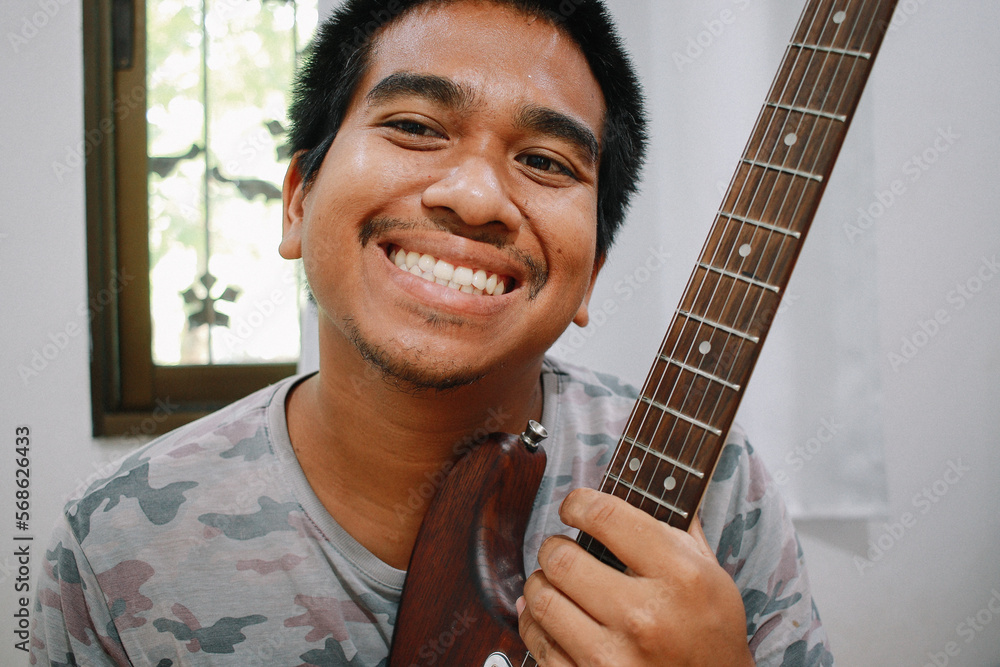 brown man playing guitar