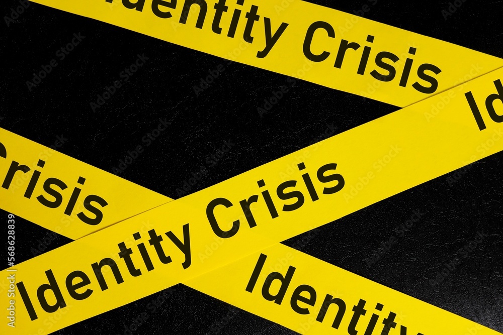 Identity crisis problem caution and warning concept. Yellow barricade tape with word identity crisis in dark black background.