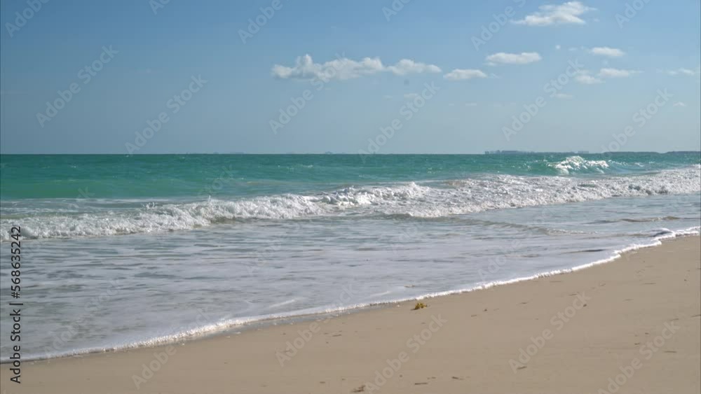 Slow motion of the waves splashing at a beach near Cancun Mexico on a warm sunny day Slow motion of the waves splashing at a beach near Cancun Mexico on a warm sunny day