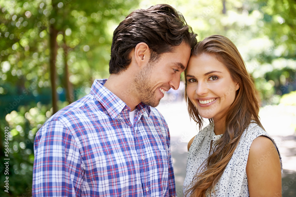 Portrait, couple and hug in park with forehead, touch and bonding against a blurred background. Face, embrace and man with woman in nature, smile and excited for reunion, relationship or togetherness Portrait, couple and hug in park with forehead, touch and bonding against a blurred background. Face, embrace and man with woman in nature, smile and excited for reunion, relationship or togetherness