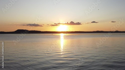 Aerial Shot: Drone going through the lake.  Sunset in San Bernardino. Peaceful evening in Lago Ypacarai photo