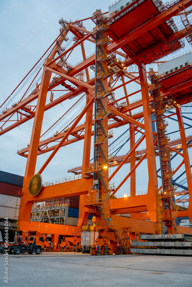 Crane loading cargo container freight container ship in the international terminal logistics sea port concept freight shipping by ship, Truck running in port under the Big Crane transport.