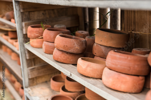 Small terracotta shallow planter pots for succulents plants for sale at a garden store. photo