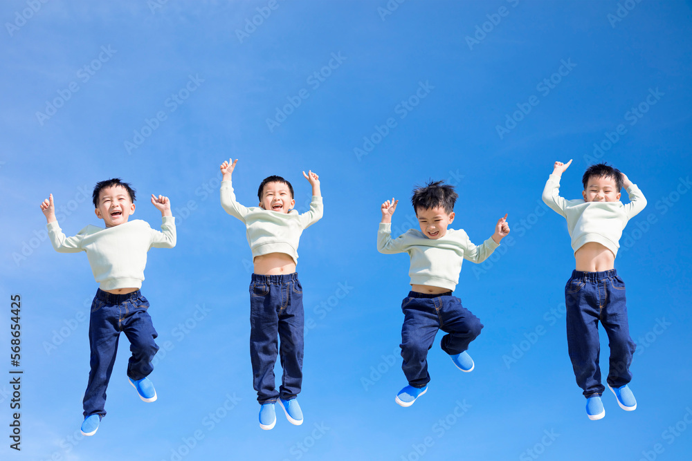 Happy kid jumping and gesturing against blue sky Happy kid jumping and gesturing against blue sky