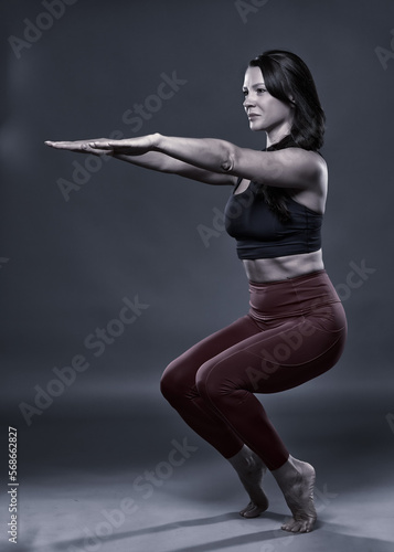 Yoga woman in Utkatasana pose © Xalanx