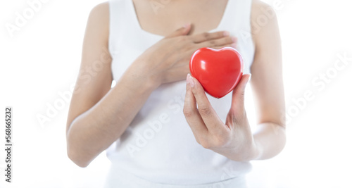 Fototapeta Naklejka Na Ścianę i Meble -  Red heart on woman hands. Symbol of support that expresses love valentine day and world heart day, heart health concept
