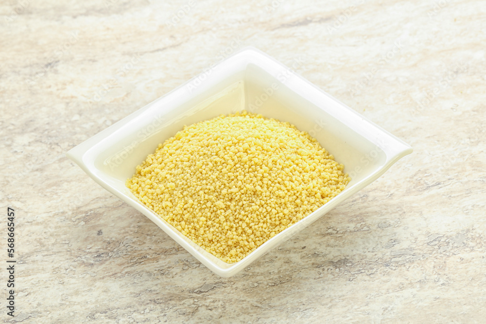 Raw couscous in the bowl Raw couscous in the bowl