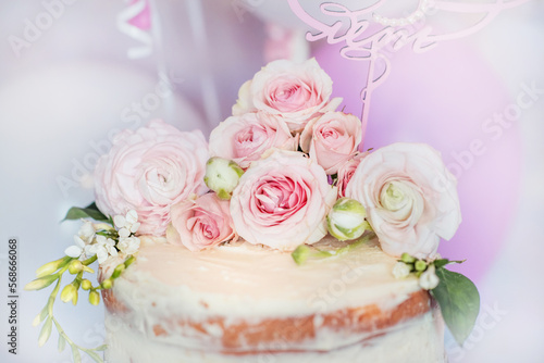 Little girl s birthday. Cake with flowers. Festive cake. Flowers on the cake. Beautiful birthday cake.