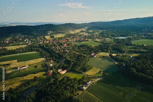 Overhead view of beautiful suburb landscape, Aerial view of countryside area with village and green fields near mountains