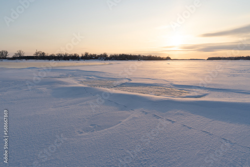Winter sunset on the big river  hummocks in the rays of the sun.
