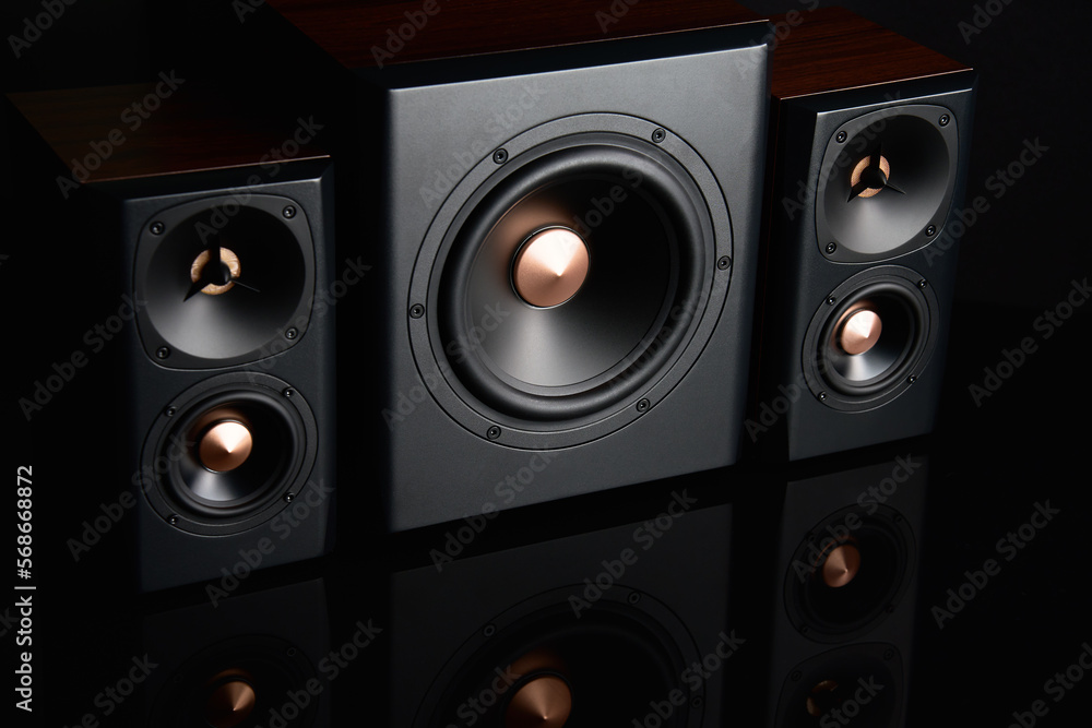 Two sound speakers and subwoofer on dark background. Set for listening music. Audio equipment Two sound speakers and subwoofer on dark background. Set for listening music. Audio equipment