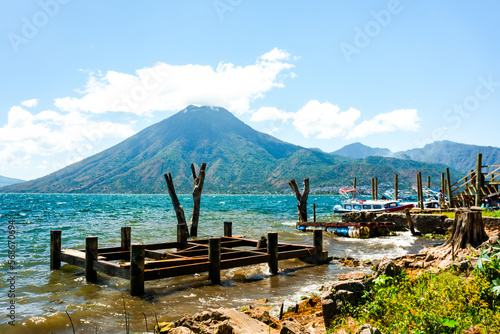 Old pier, lake and volcanoes, Lake Atitlan Guatemala photo