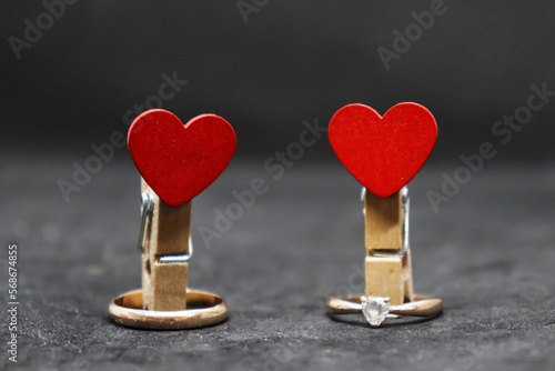 Clothespins with hearts and wedding rings