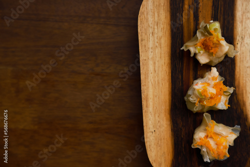 Flat lay of traditional chinese dimsum serve on a wooden table