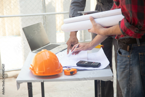 Engineering team consulting and analyzing building projects construction site .Home concept Offer Management