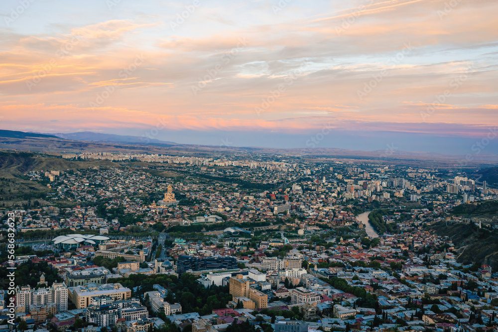 View of Tbilisi, the capital of Georgia, at sunset from above. Overview of the city from a mountain