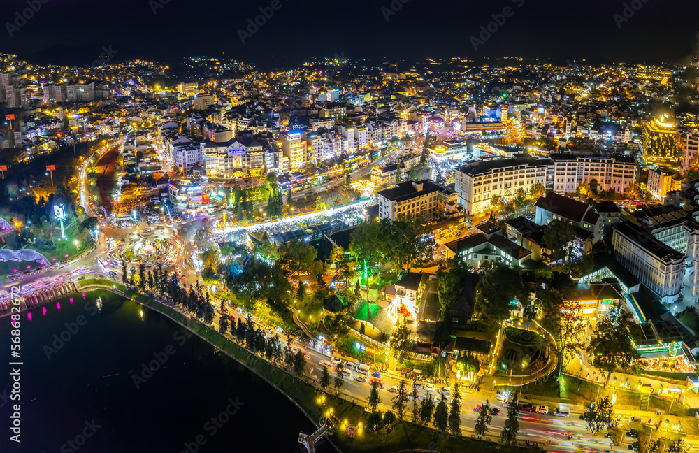 Aerial view of Da Lat city night beautiful tourism destination in central highlands Vietnam. Urban development texture, green parks and city lake.