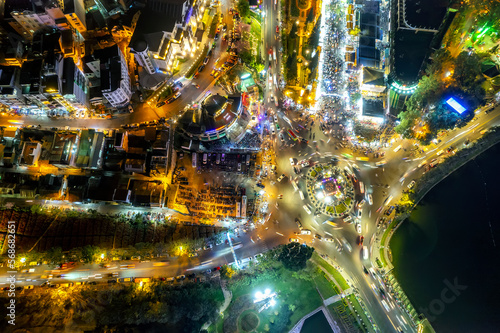 Fototapeta Naklejka Na Ścianę i Meble -  Aerial view of Da Lat city night beautiful tourism destination in central highlands Vietnam. Urban development texture, green parks and city lake.
