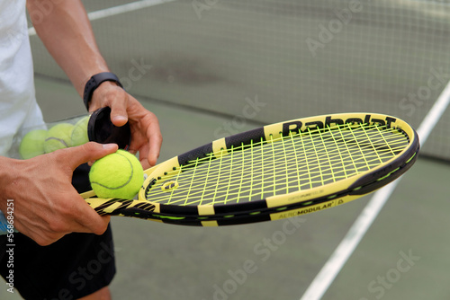close-up. male hands holding tennis racket and balls © alexzhilkin