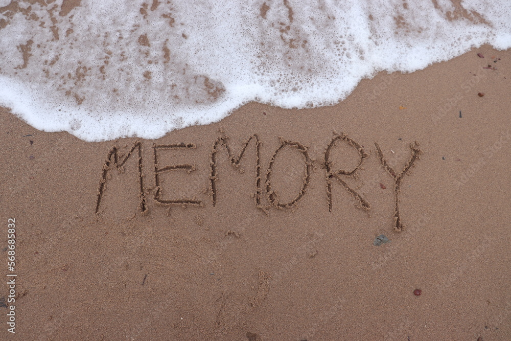 Fototapeta premium Writing the letters m e m o r y or memory on the sand and the sea water is flowing to erase this memory. Ideas for wanting to forget the bad things. or erase anything bad from your mind