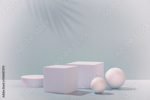 Abstract empty geometric shape podiums for product on pastel blue background.