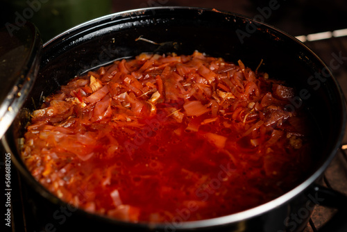 Saucepan with red Ukrainian borscht. The national dish is a soup of cabbage, beets and vegetables in meat broth.