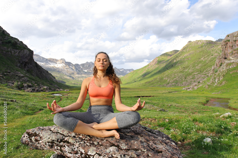 Yogi doing yoga exercise in a mountain valley Yogi doing yoga exercise in a mountain valley