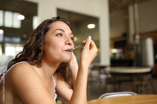 Woman using spoon in a coffee shop