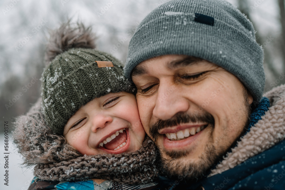 Father and son having fun in snow Father and son having fun in snow