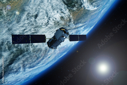 Space communications satellite above the earth. Elements of this image furnished by NASA