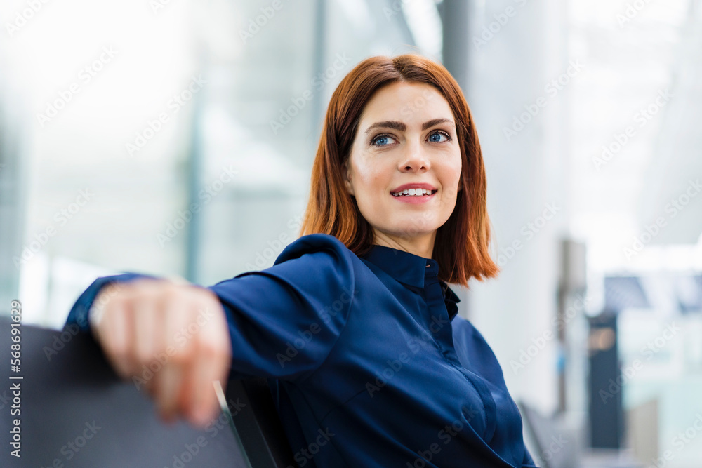 Thoughtful businesswoman sitting on chair Thoughtful businesswoman sitting on chair