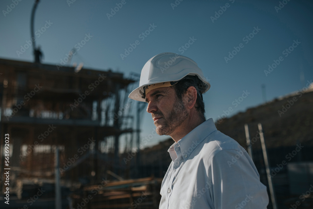 Thoughtful mature architect at construction site Thoughtful mature architect at construction site