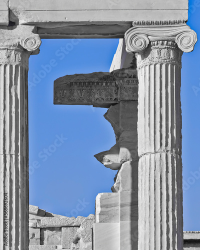 Detail of the pediment and the capital of Ionic style column of the ancient Temple of Erechtheion on the Acropolis. Cultural trip to Athens, Greece. photo