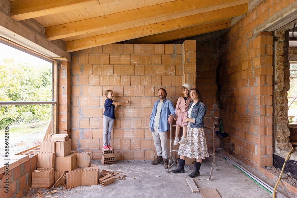 Happy family with daughters at construction site Happy family with daughters at construction site