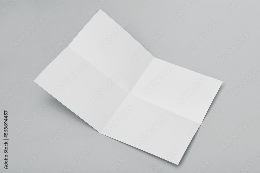Blank paper folded on gray background Blank paper folded on gray background