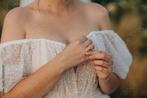 Engagement ring on bride's finger.