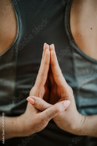 Woman with hands clasped doing Paschim Namaskarasana photo