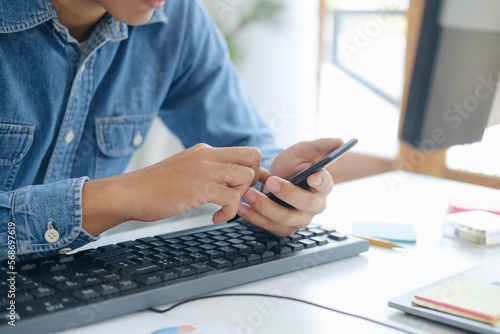 Wallpaper Mural Close up of man using mobile phone. Torontodigital.ca