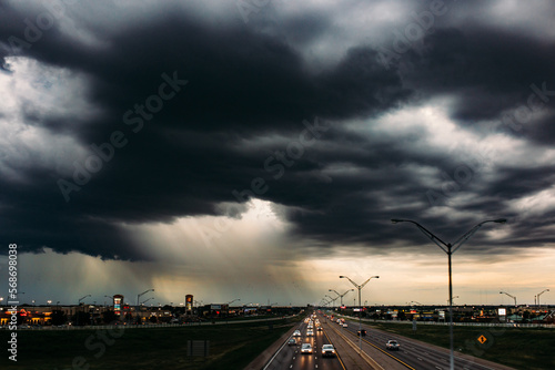 Clouds opening with rain falling over the city