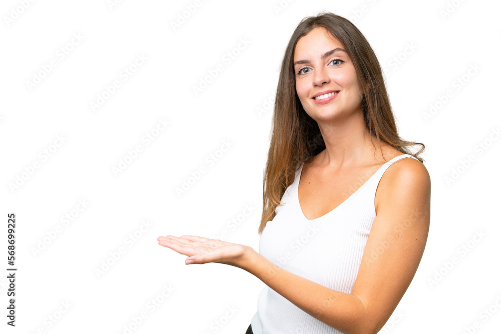 Young pretty woman over isolated background presenting an idea while looking smiling towards Young pretty woman over isolated background presenting an idea while looking smiling towards